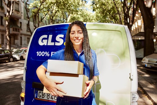 international shipping delivery driver with parcels in hands