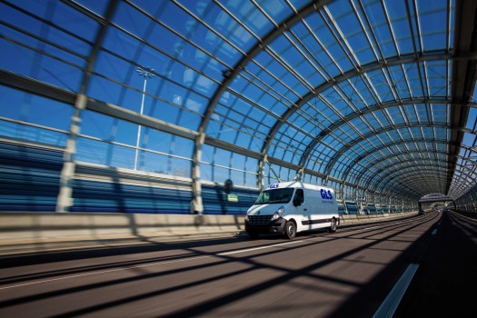 GLS parcel delivery van driving through a glass tunnel”
